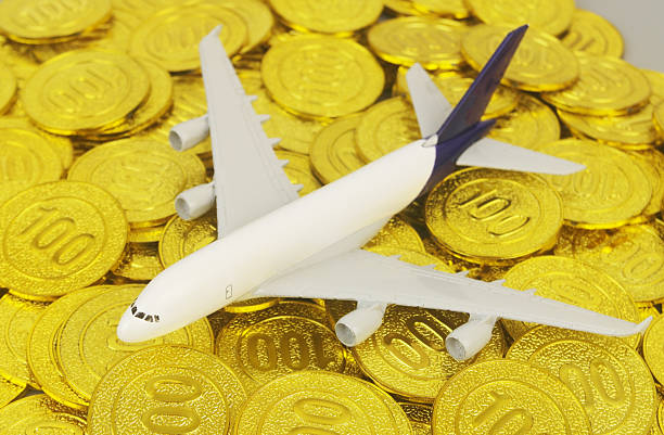 istock Airplane model on gold coins 2232466978