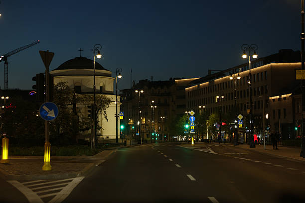 istock Serene Night Cityscape: Empty Street, Classic Architecture, Soft Lighting, Tranquil Mood, European City, Nighttime, Urban, Calm, Peaceful, Construction Crane in Background,  Architectural Details, Streetlights, Traffic Signs. 2232467044