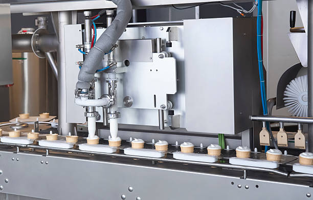 istock Automatic production line machine fills waffle cups with vanilla ice cream 2232469248