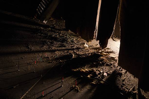Dark and Mysterious Attic Interior with Debris and Light, Perfect for Thriller Concepts.