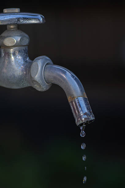 istock Drops of water falling from a faucet 2232472497