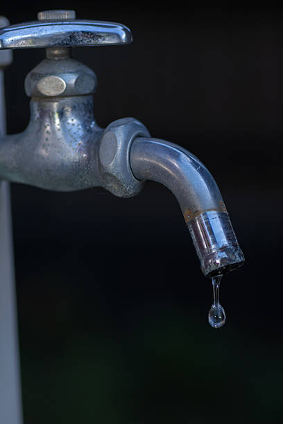istock Drops of water falling from a faucet 2232472517