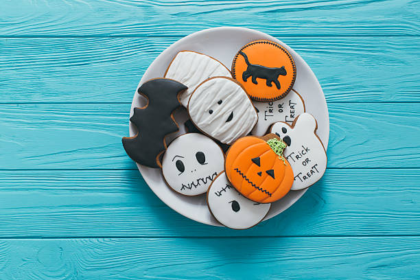 istock Fresh halloween gingerbread cookies on blue wooden table. 2232472775