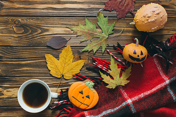 Preparing for Halloween: Autumn decor, pumpkins, plaid, leaf, gingerbread and coffee.