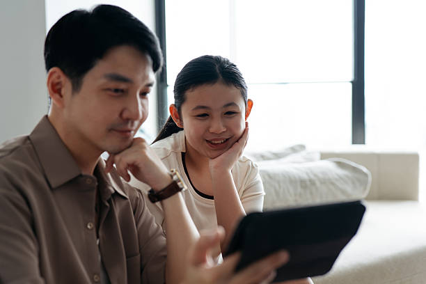 istock Smiling Dad and Daughter Using Tablet for Selfie 2232473412