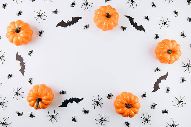 istock Halloween concept. Pumpkins, spiders and bats on white background. Flat lay, top view, copy space 2232473585