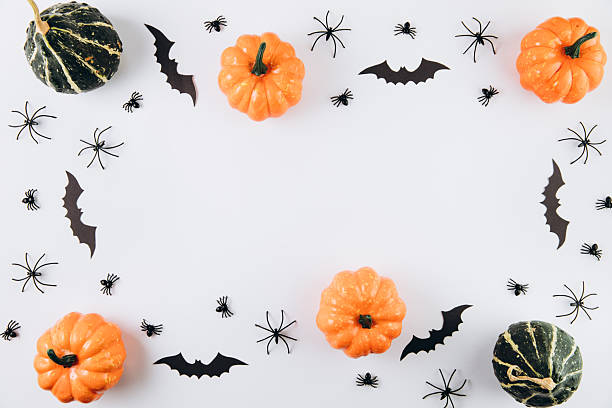istock Halloween concept. Pumpkins, spiders and bats on white background. Flat lay, top view, copy space 2232473603