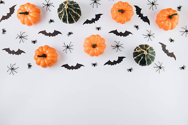 istock Halloween concept. Pumpkins, spiders and bats on white background. Flat lay, top view, copy space 2232473604