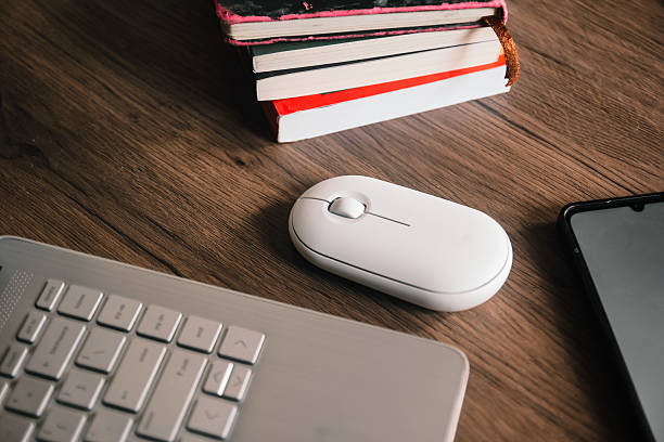 istock Smartphone with blank screen next to a laptop and mouse. 2232475100