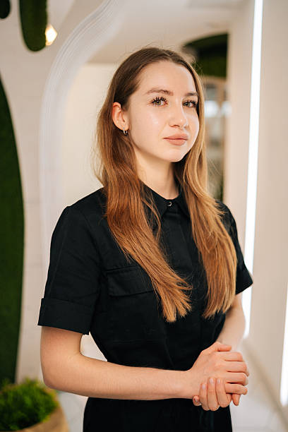 istock Confident young female nurse wearing black uniform standing posing looking at camera in modern clinic interior, exuding professionalism 2232475923