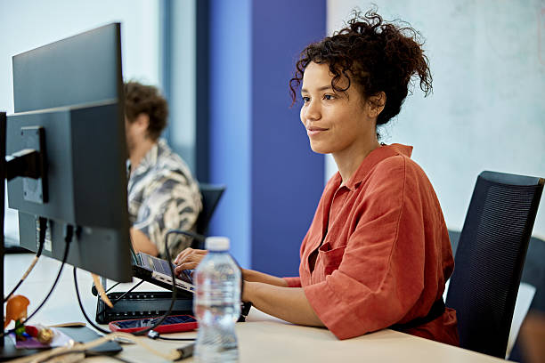 istock Hispanic businesswoman hot-desking in modern office 2232477458