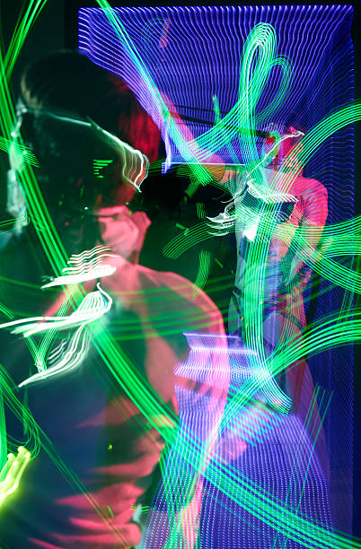 istock Young male performer showing light patterns using LED poi reflecting in the mirror 2232479078