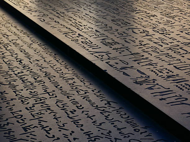 Close-up of a weathered stone slab featuring a Greek inscription from the Roman period, displayed in the Antalya Museum, Turkey. The text honors the people and council, referencing the archon Antiokhos Filopator and a dedication by Likos for peace and goodwill. The carved uppercase letters and aged surface reflect the civic and ceremonial traditions of ancient Anatolian cities under Roman influence. Ideal for historical, archaeological, and epigraphic studies.