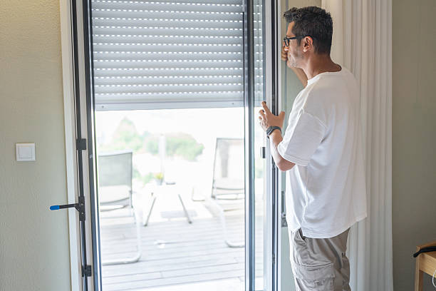 istock Man Opening Roller Blind Jalousie On Pvc Balcony Door 2232483716