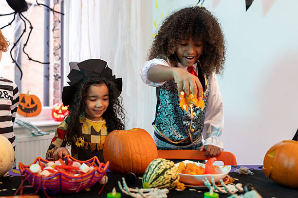 istock Brother and Sister Carving Pumpkins 2232484543