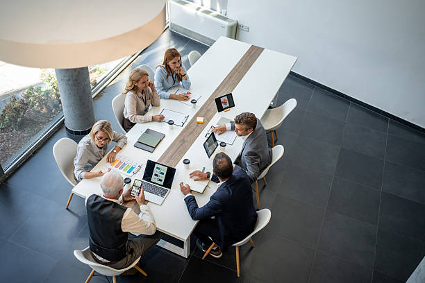 istock Business people working together at meeting table analyzing financial charts 2232485035