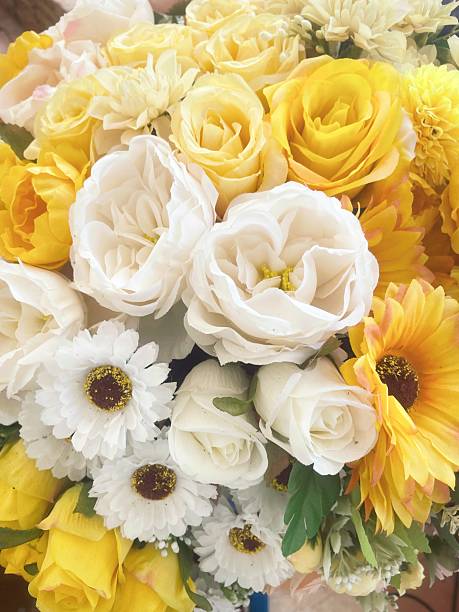 A close-up of a cluster of bright yellow sunflowers in full bloom, highlighting the vibrant petals and dark centers. The image exudes warmth and happiness, capturing the essence of a sunny summer day