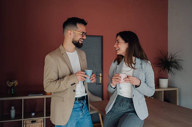 istock Business partners enjoying a coffee break and smiling at each other 2232487779