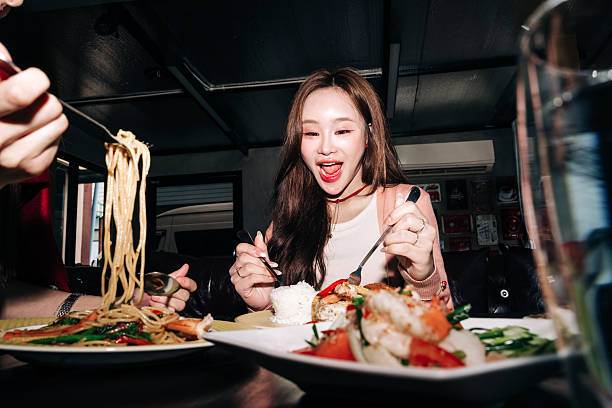 istock Happy friends eating Asian cuisine in cozy setting 2232487798
