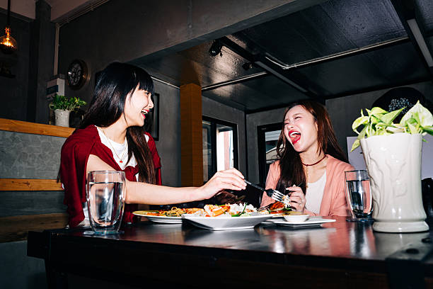istock Laughing friends enjoying lunch at cozy restaurant 2232487890