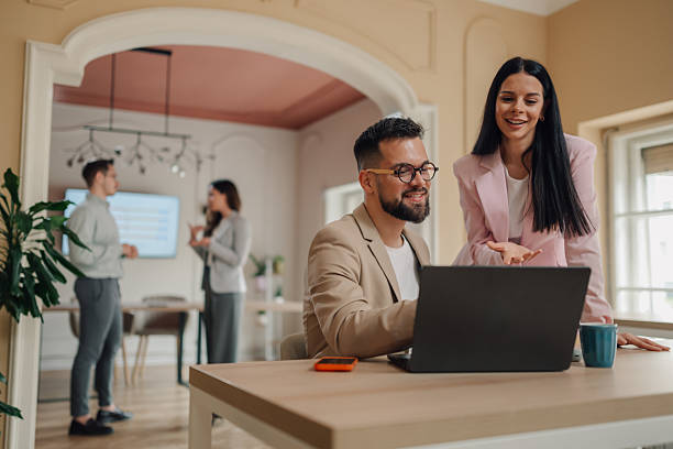 istock Business colleagues collaborating on laptop in modern office 2232488080