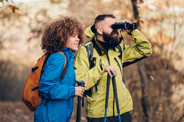 istock Hikers observing nature with binoculars in autumn forest 2232488528