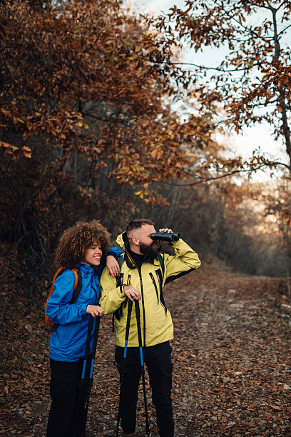 istock Hikers observing nature with binoculars in autumn forest 2232488636