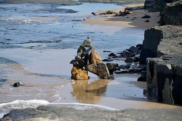 Rock balancing statue formation on the beach