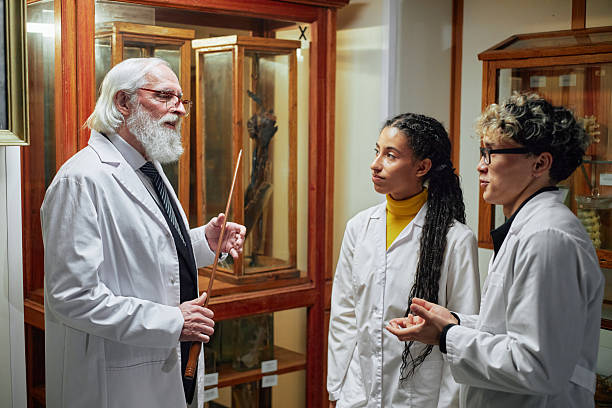 istock Senior Caucasian Man Explaining Specimens to Young Multiethnic Scientists 2232493181
