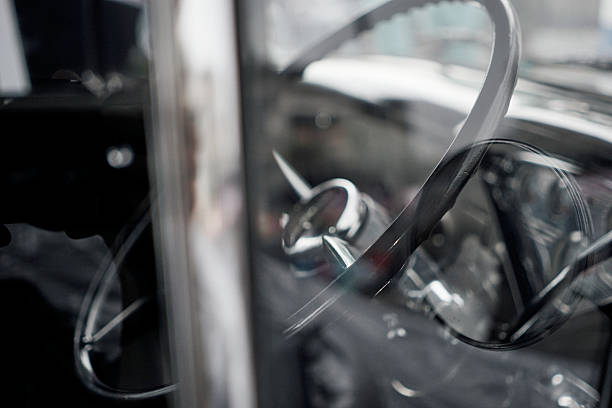 istock Retro Car Interior with Thin Steering Wheel Seen Through Glass 2232493203