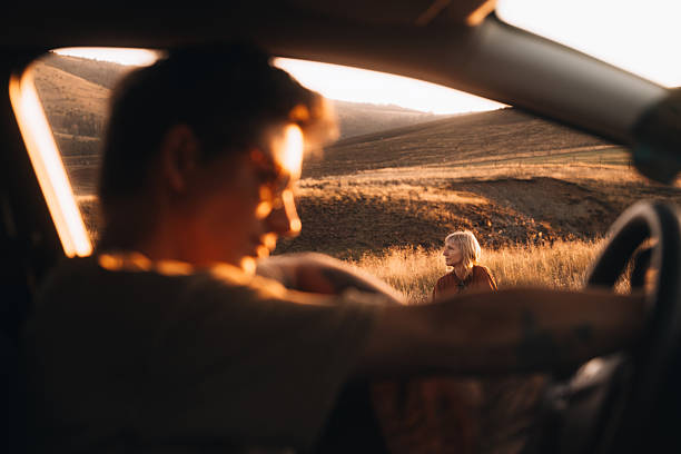 istock Travel Scene with Two People at Sunset 2232494091