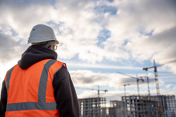 istock Construction Worker Observing Site With High-Rise Buildings 2232494419