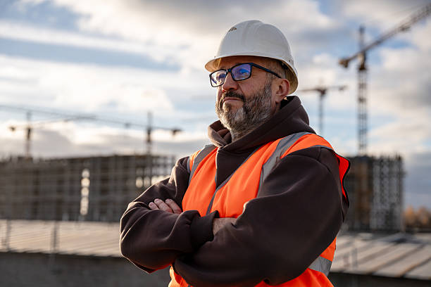istock Construction Worker Wearing Safety Gear at Building Site 2232494493