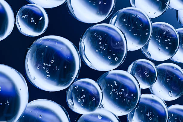 istock Transparent blue water bubbles floating on a dark background. Abstract 3D render symbolizing hydration, freshness, purity, and skincare. Clean minimal concept for cosmetic or science themes. 2232494694