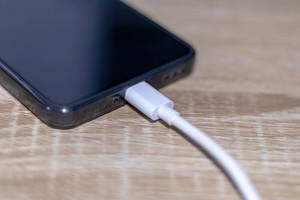 istock A smartphone being charged on the wooden table 2232494833