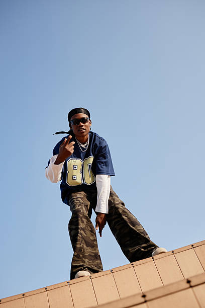 istock Young Adult Black Man Standing on Rooftop Gesturing Toward Camera 2232496534