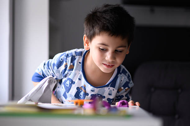 istock Curious child playing with modeling clay at home 2232496898