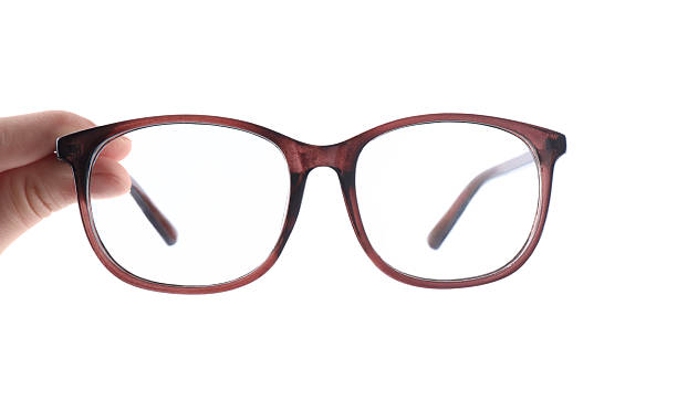 istock Woman holding glasses with brown frame on white background, closeup 2232497694