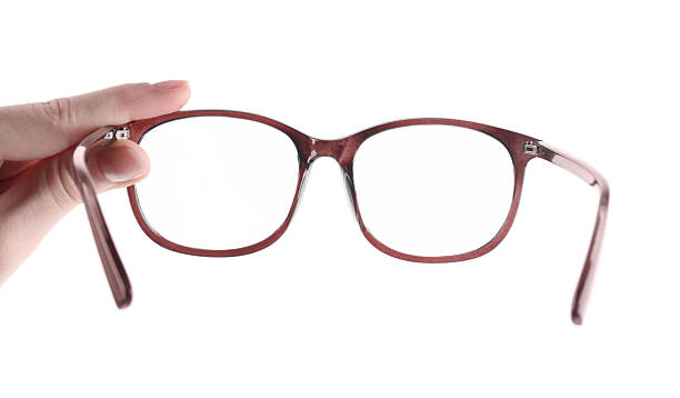 istock Woman holding glasses with brown frame on white background, closeup 2232497702