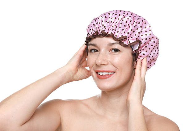 istock Woman wearing pink shower cap on white background 2232500129