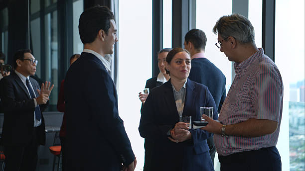 istock Business professionals networking and enjoying drinks at a corporate event 2232500599