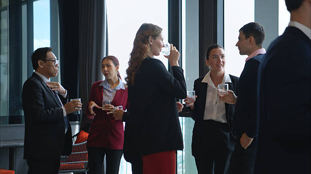 istock Business professionals networking and enjoying drinks at a corporate event 2232500633