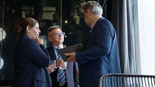 istock Business professionals networking and enjoying drinks at a corporate event 2232500746
