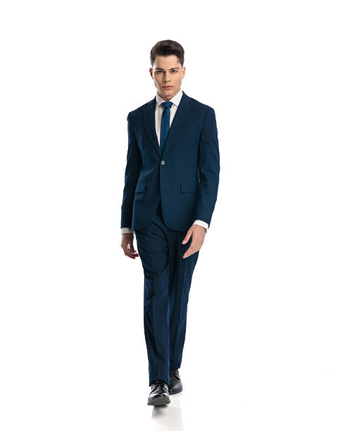 istock sexy elegant man in navy blue suit with tie walking and looking forward 2232501382