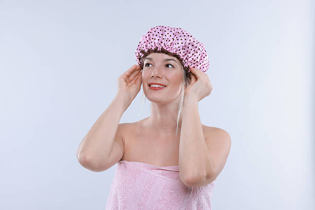 istock Woman wearing shower cap on white background 2232501771