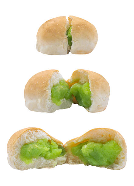 Three stages of a soft bun revealing its sweet pandan custard filling. From whole to split, each bite promises a creamy, tropical delight typical of beloved Asian snacks.