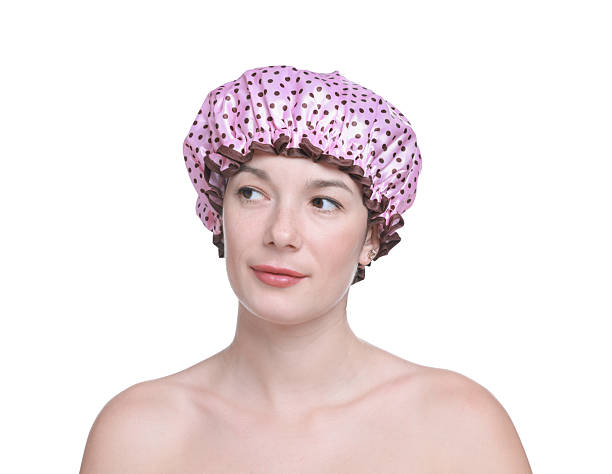 istock Woman in pink shower cap on white background 2232505131