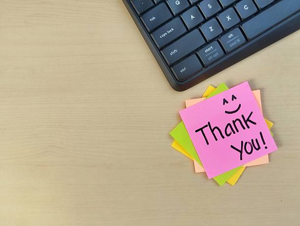 istock Thank you message on sticky note with wooden table background, Top view 2232506790