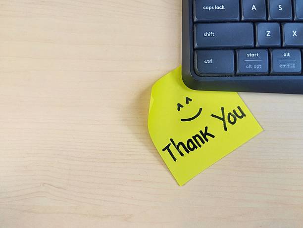 istock Thank you message on sticky note with wooden table background, Top view 2232506794