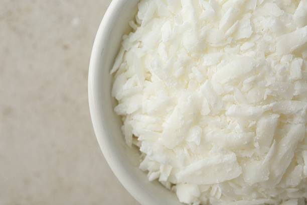 istock Soy wax in bowl on light grey table, top view 2232509530